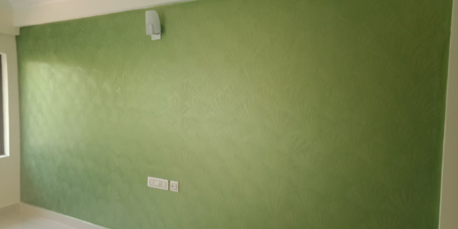 Worker painting a wall